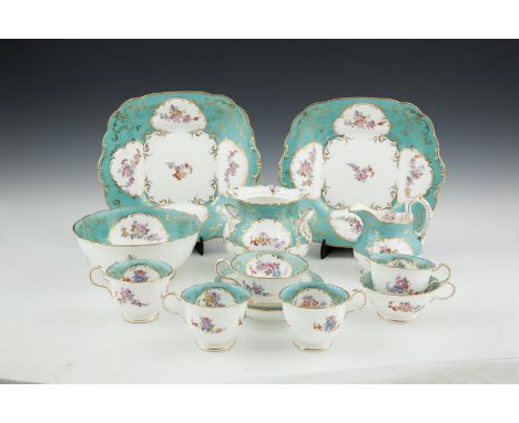 A VICTORIAN ROCKINGHAM STYLE CHINA PART TEA SERVICE, painted with groups of summer flowers within gilt borders against a turq