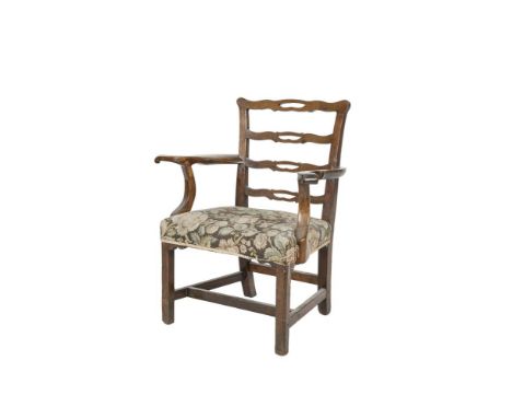 A GEORGE III MAHOGANY FRAMED PIERCED LADDER BACK ELBOW CHAIR with outswept armrests, padded seat and raised on chamfered squa