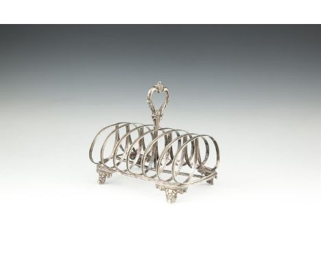 A VICTORIAN SILVER SIX BAR TOAST RACK, London 1851, mark of John Evans II, having raised foliate scroll handle, reeded bars o