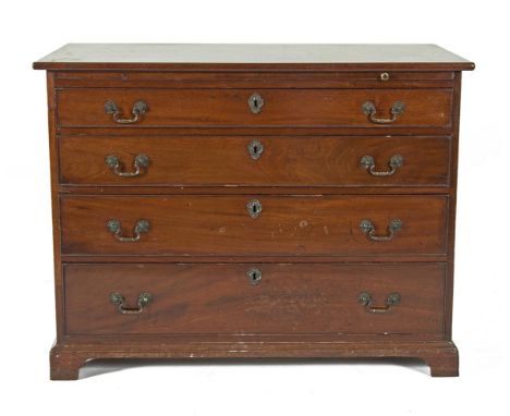 A GEORGE III MAHOGANY CHEST of four long graduated drawers below a slide with green baise inset, the moulded base on bracket 