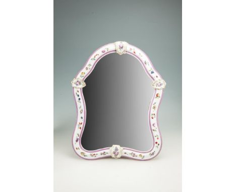 A CONTINENTAL PORCELAIN CARTOUCHE SHAPED EASEL DRESSING TABLE MIRROR, the white ground painted with fruit and flowers  