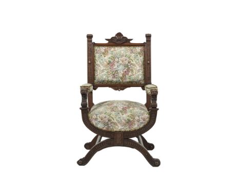 A 19TH CENTURY CARVED AND STAINED OAK FRAME ARMCHAIR, the upholstered padded back, armrests and seat covered in tapestry clot