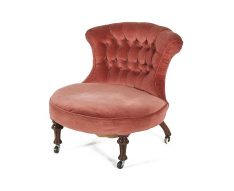 A 19TH CENTURY MAHOGANY AND UPHOLSTERED LOW CHAIR, with curved button back and padded seat on fluted tapering supports