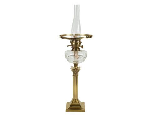 A BRASS CORINTHIAN COLUMN OIL LAMP, with cut clear glass resevoir, lacking shade