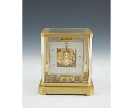 A JAEGER LE COULTRE ATMOS MANTLE CLOCK, in fitted case, with clear glass top and side panels, angled corners and squared dial