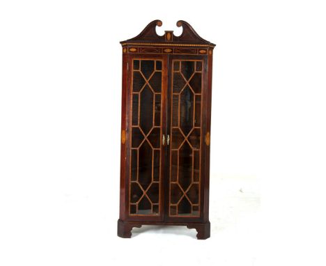 A MAHOGANY AND SATINWOOD CROSS BANDED AND EBON STRUNG CORNER CABINET, 19th century, with broken swan neck pediment with inlai