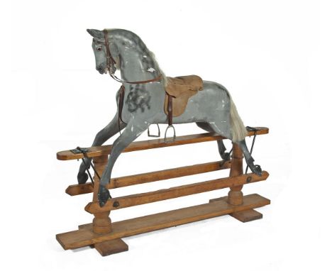 A VICTORIAN TIMBER AND GESSO ROCKING HORSE, of large proportions, the dappled grey painted horse with leather saddle, bridle 