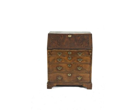 A GEORGE III MAHOGANY AND WALNUT GENTLEMAN'S BUREAU, the sloped drop front opening to reveal a fitted interior with drawers a