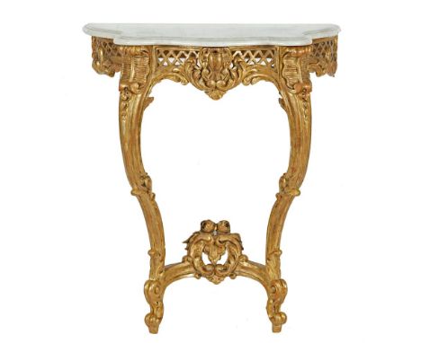 A CARVED GILTWOOD AND GESSO CONSOLE TABLE OF COMPACT PROPORTIONS, the white veined marble top with moulded rim above a pierce