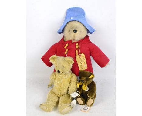 A Paddington Bear wearing duffle coat, hat and Wellington boots, complete with label, height 44cm excluding hat, a modern Ste