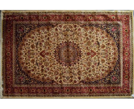 A large beige ground Keshan carpet with large central motif within floral set border, 280 x 200cm.