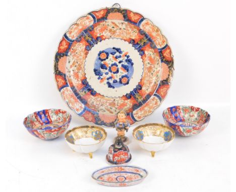 A Japanese Meiji period Imari charger, diameter 40.5cm, with wire wall mounts, a pair of similar bowls, an enamel dish and a 