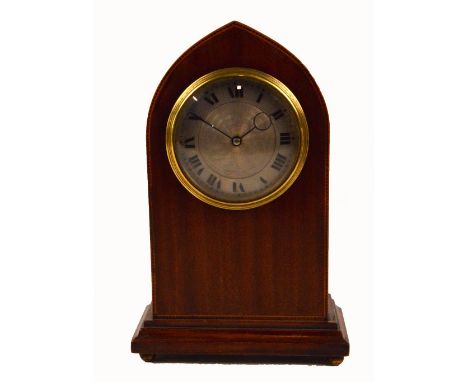 An Edwardian mahogany and inlaid lancet shaped mantel clock, the circular silvered and engine turned decorated dial set with 