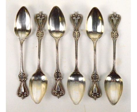 A set of six early 20th century American sterling silver teaspoons with scroll and bead decorated stems, finials initialled T
