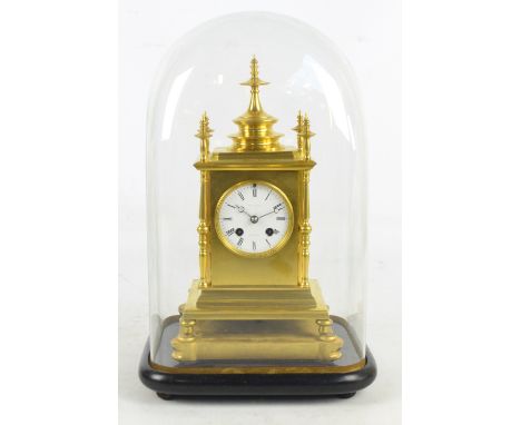 A late 19th century gilded brass eight day mantel clock with circular white enamel dial set with Roman numerals, indistinctly