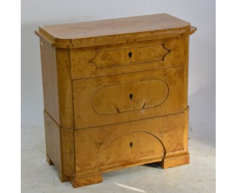A 19th century Biedermeier commode, the shaped stepped moulded rectangular top above three drawers raised on rectangular low 