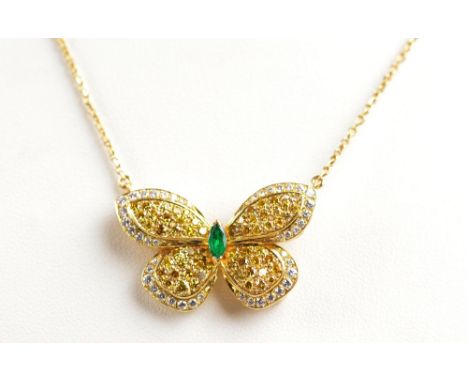 VAN CLEEF AND ARPELS; an 18ct gold emerald and diamond butterfly necklace, the pendant centred with a marquis cut emerald, th