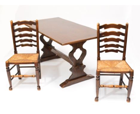 A reproduction oak refectory table and four rush seated wavy ladder back chairs (5).