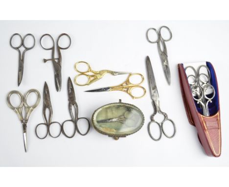 A collection of scissors including a 19th century graduated set of three Brookes and Crookes scissors in a red case, four pai