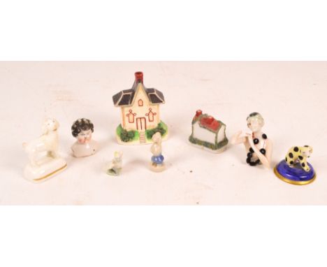 A collection small ceramic items including a Staffordshire pastille burner and two pin cushion dolls.
