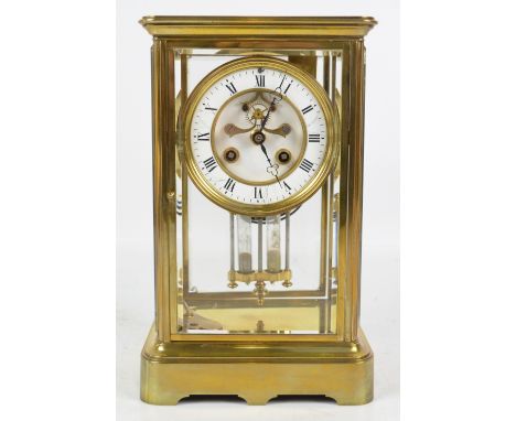 A late 19th century French brass four glass mantel clock, with two piece white enamel dial set with Roman numerals, visible e
