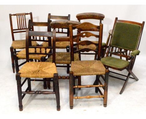 A set of three 19th century rustic bar back dining chairs, a pair of elm bar back chairs, a ladder back chair, vertical splat
