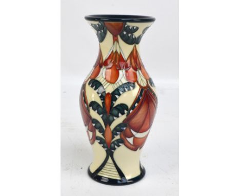 A modern Moorcroft floral tube lined decorated baluster vase with cream ground and flared rim, marked to base, dated 2009 wit