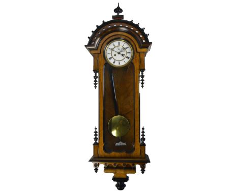 A 19th century walnut and ebonised twin weight Vienna wall clock, with two piece white enamel dial and arched pediment, heigh