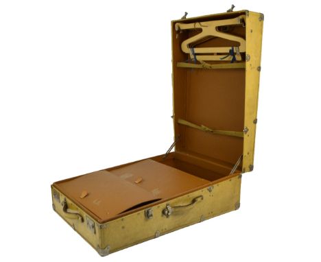A vintage vellum covered travel trunk, the brown simulated leather interior with hangers and three compartments, 75 x 53 x 26