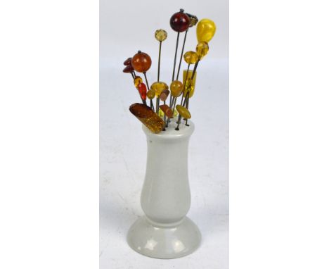 A collection of amber coloured headed hat pins of varying shapes and sizes including globular examples, faceted examples, etc