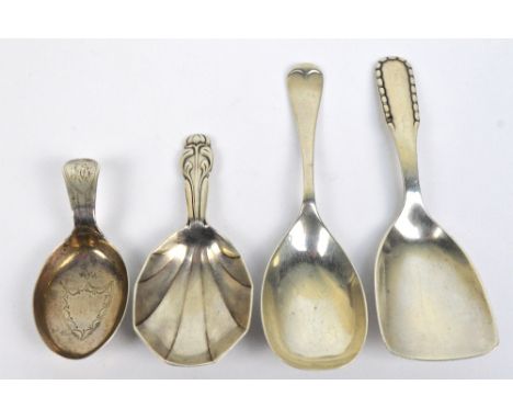 A group of four variously hallmarked silver caddy spoons to include a George V hallmarked silver example with faceted bowel a