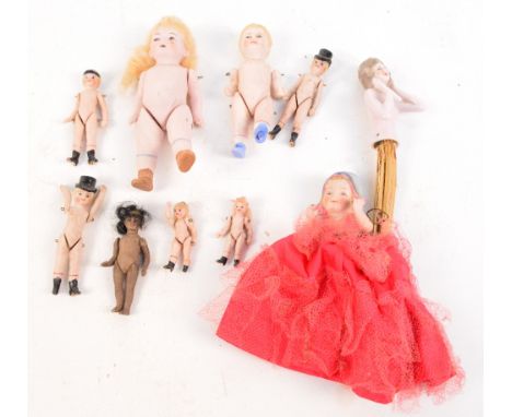 A collection of late 19th/early 20th century ceramic dolls in various sizes including two very small, two with top hats on, o
