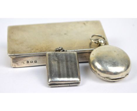 A George V hallmarked silver rectangular stamp box with sloping spring loaded lid enclosing gilt wash three division interior