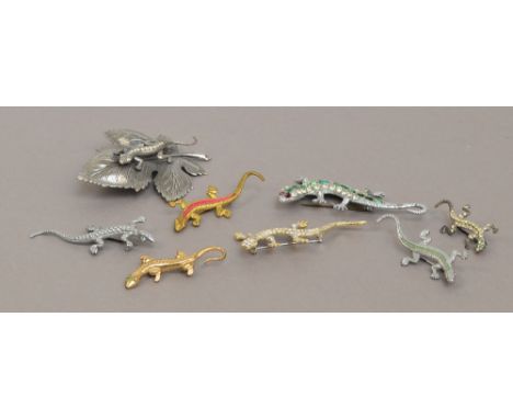 A collection of eight lizard costume jewellery brooches including a lizard on a leaf, a lizard with green enamel back and red