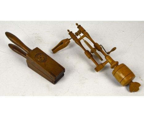 A late 19th/20th century treen lemon squeezer with turned handles and angled main body, length 28cm, and an early 20th centur