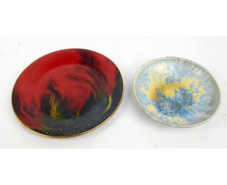 A studio pottery yellow glazed circular shallow bowl with blue enamel straw effect floral decoration, impressed monogram to t