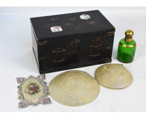 An Oriental ebonised trinket box with drawers, hinged lid decorated with ceramic panels enclosing compartments, width 26cm, t