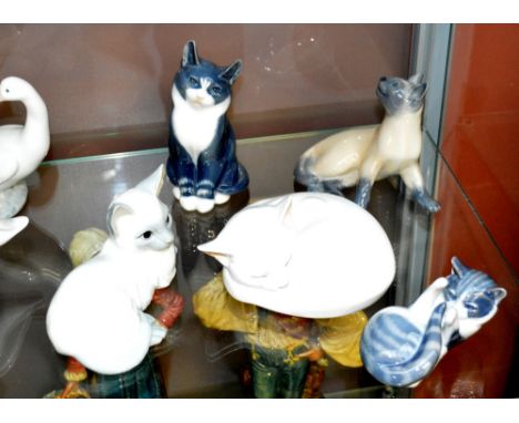 Five Royal Copenhagen ceramic cats, in various positions (5).