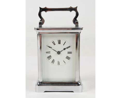 An early 20th century nickel plated French carriage clock with swing loop handle and white enamel dial set with Roman numeral