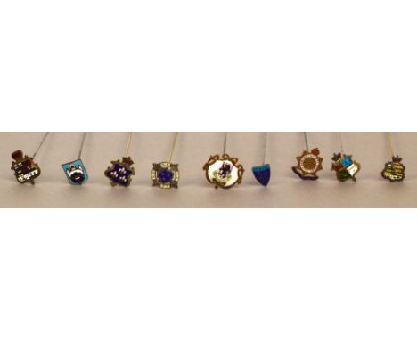 A collection of nine Heraldic hat pins bearing various coats of arms and town crests, including a hallmarked silver and ename