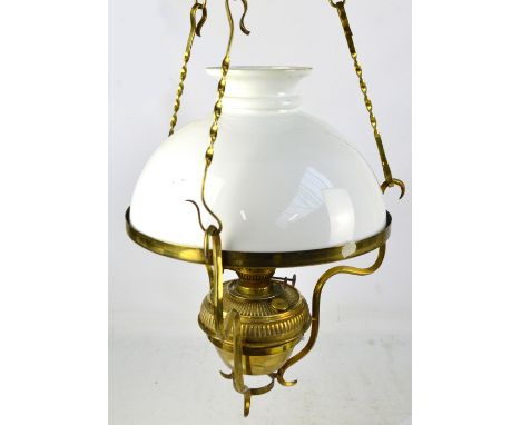 A brass framed ceiling light with opaque glass shade, gadrooned reservoir and square section supports, purportedly converted 
