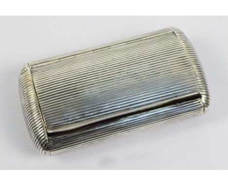 A late 19th/early 20th century French snuff box of rounded rectangular form with overall linear decoration and gilt wash inte