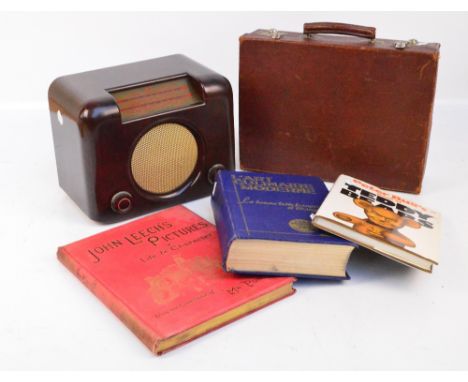 A vintage brown bakelite radio, a small leather case and three books (5).