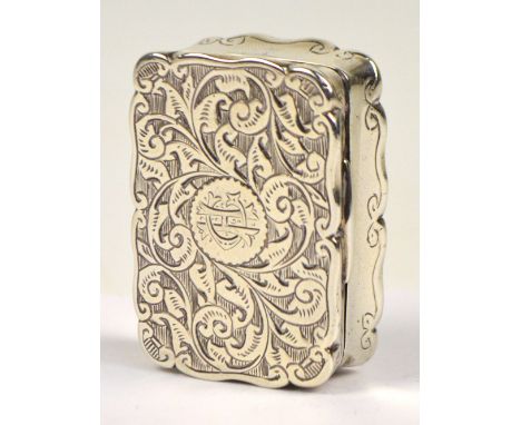 A Victorian hallmarked silver snuff box of shaped rectangular form engraved with foliate scrolls to base and hinged lid centr