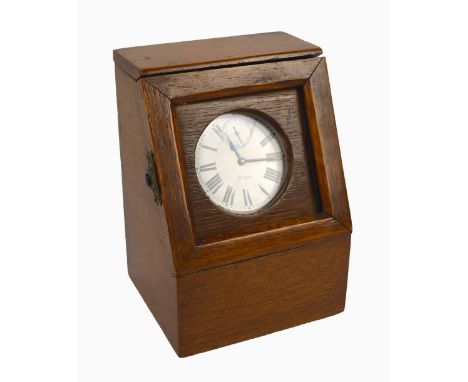 An early 20th century silver plated cased eight day travelling clock modelled as an oversized open face crown wind pocket wat