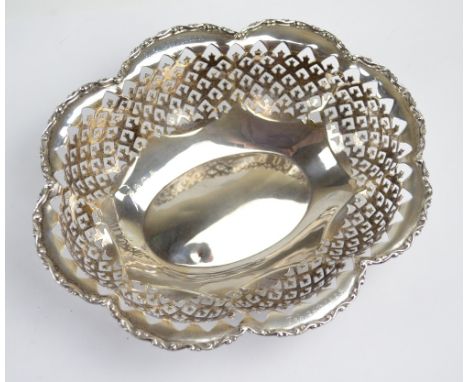 A George V hallmarked silver bowl of lobed oval form with pierced sides, maker's mark partially rubbed, Birmingham 1924, insc
