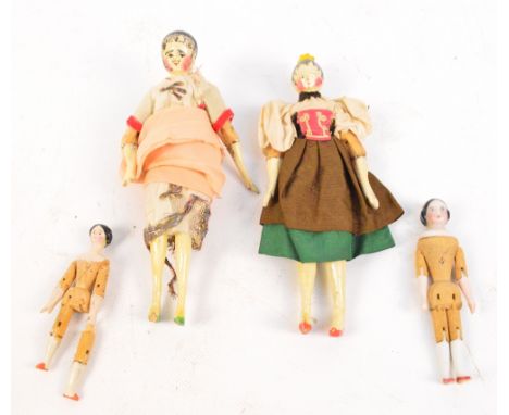 Two 19th century wooden dolls with articulated knees and elbows, height 18cm and two smaller 19th century dolls with articula