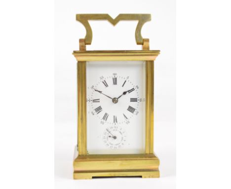 A c.1900 French brass cased calendar carriage clock with swing loop handle above white enamel dial set with Roman numerals an