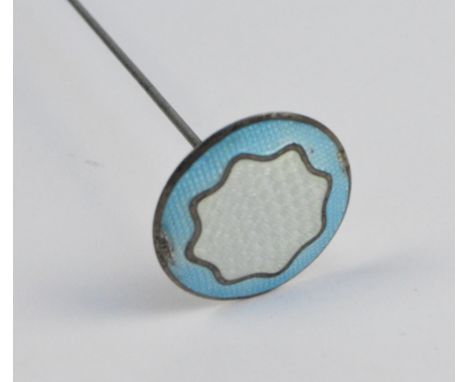 A sterling silver and guilloche enamel circular hat pin with central white section surrounded by pale blue, head diameter 2.5
