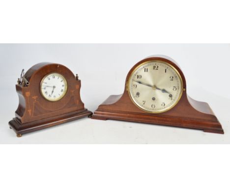 A mahogany Napoleon's hat eight day chiming mantle clock, the circular dial set with Arabic numerals, on bracket feet, width 